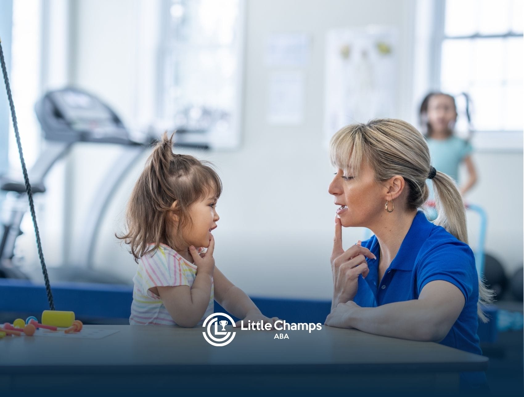 A little girl doing ABA therapy with her ABA therapist in a center-based setting.