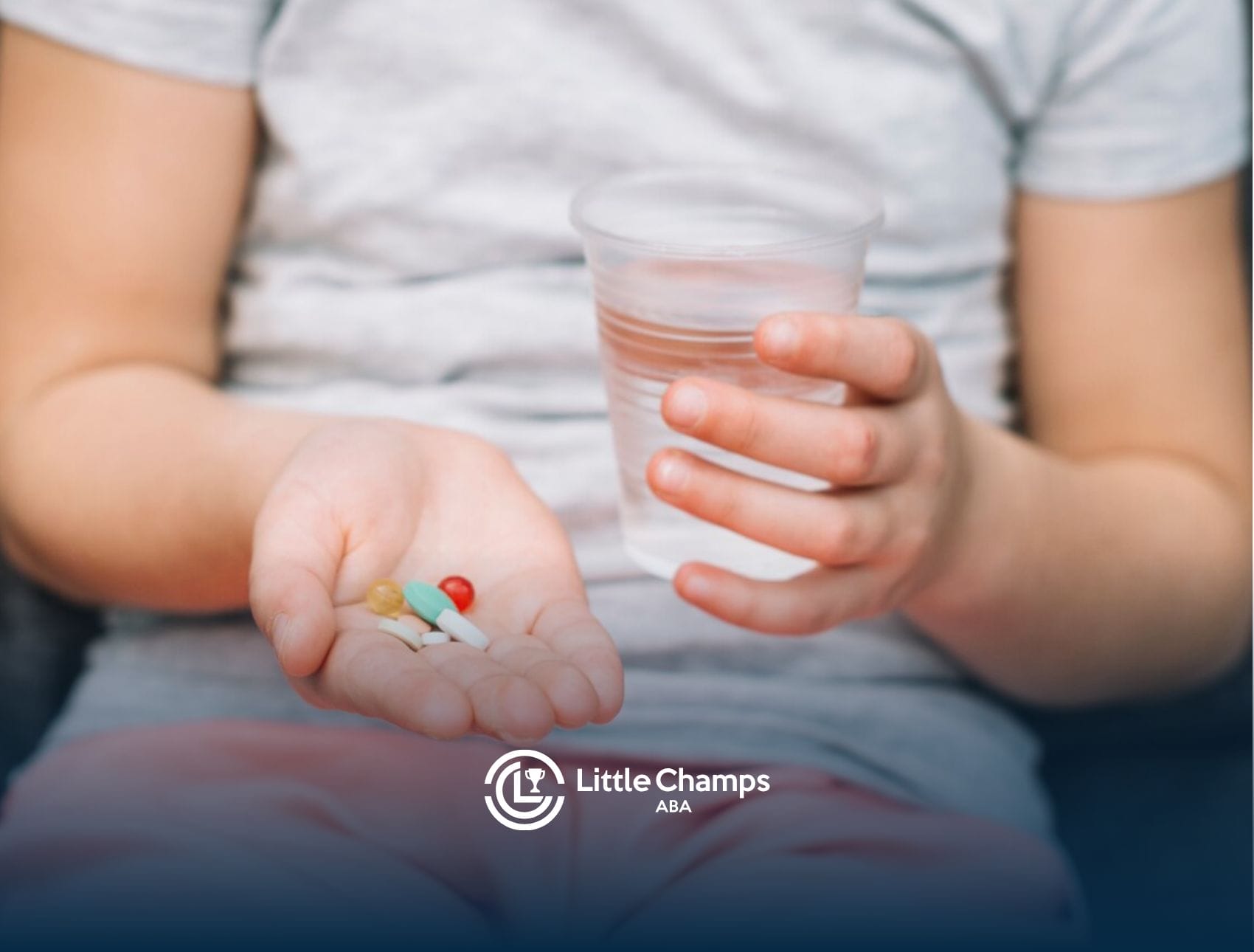 A person with autism is holding a glass of water and a few supplements